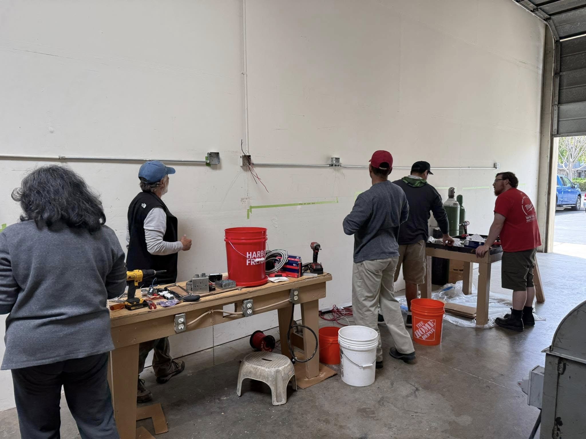Members setting up conduit for new shop.
