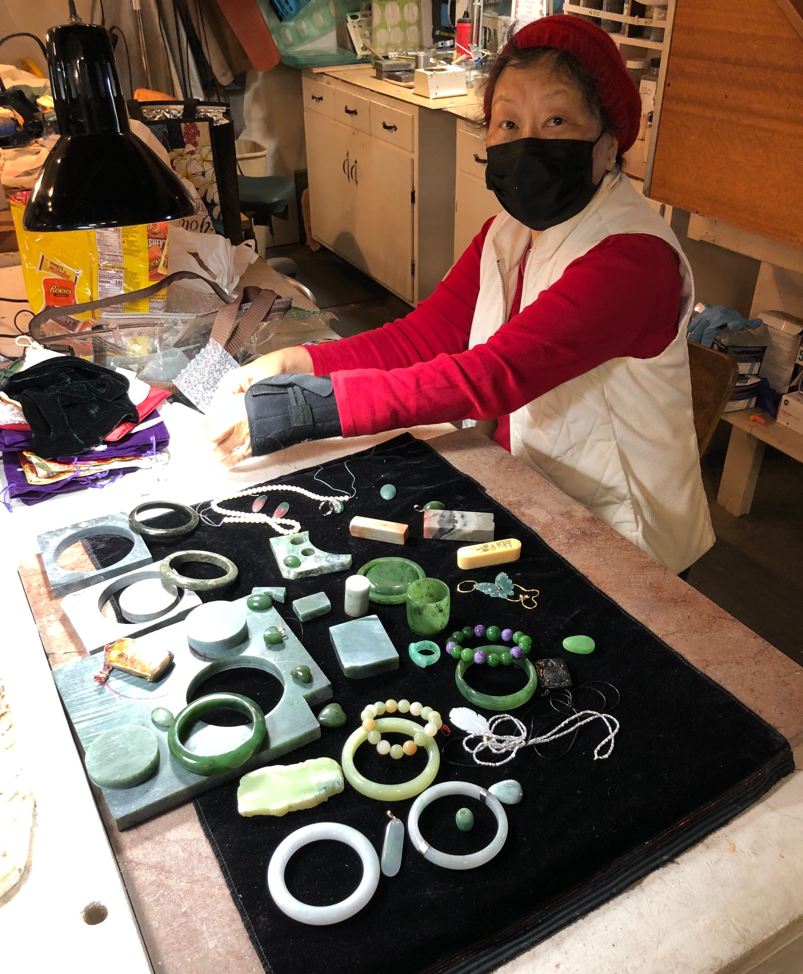 Club member making jade bracelets and beading.