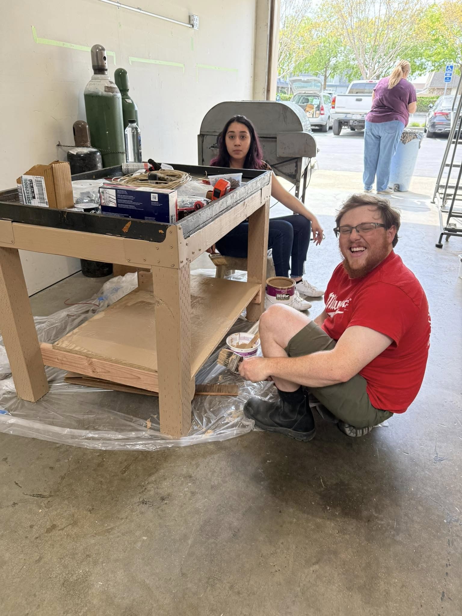 Club members painting new tables.